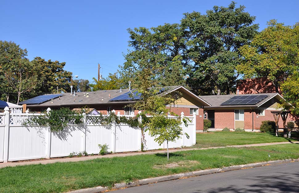 Photo of Northeast Denver Housing’s Whittier affordable housing project with rooftop solar.