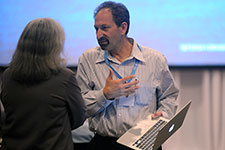 Image of Doug Arent talking with a participant at the IPCC.