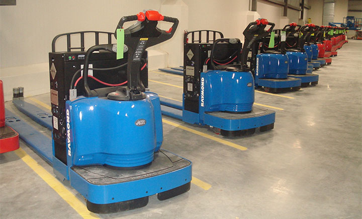 Forklifts lined up in a warehouse