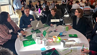 A group of people talking around a conference table